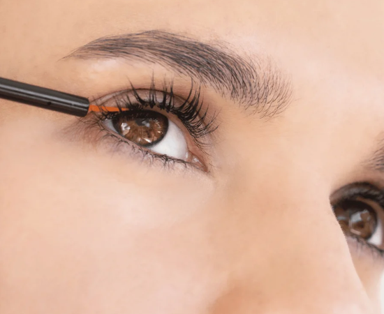 Woman applying lash serum as part of her beauty routine